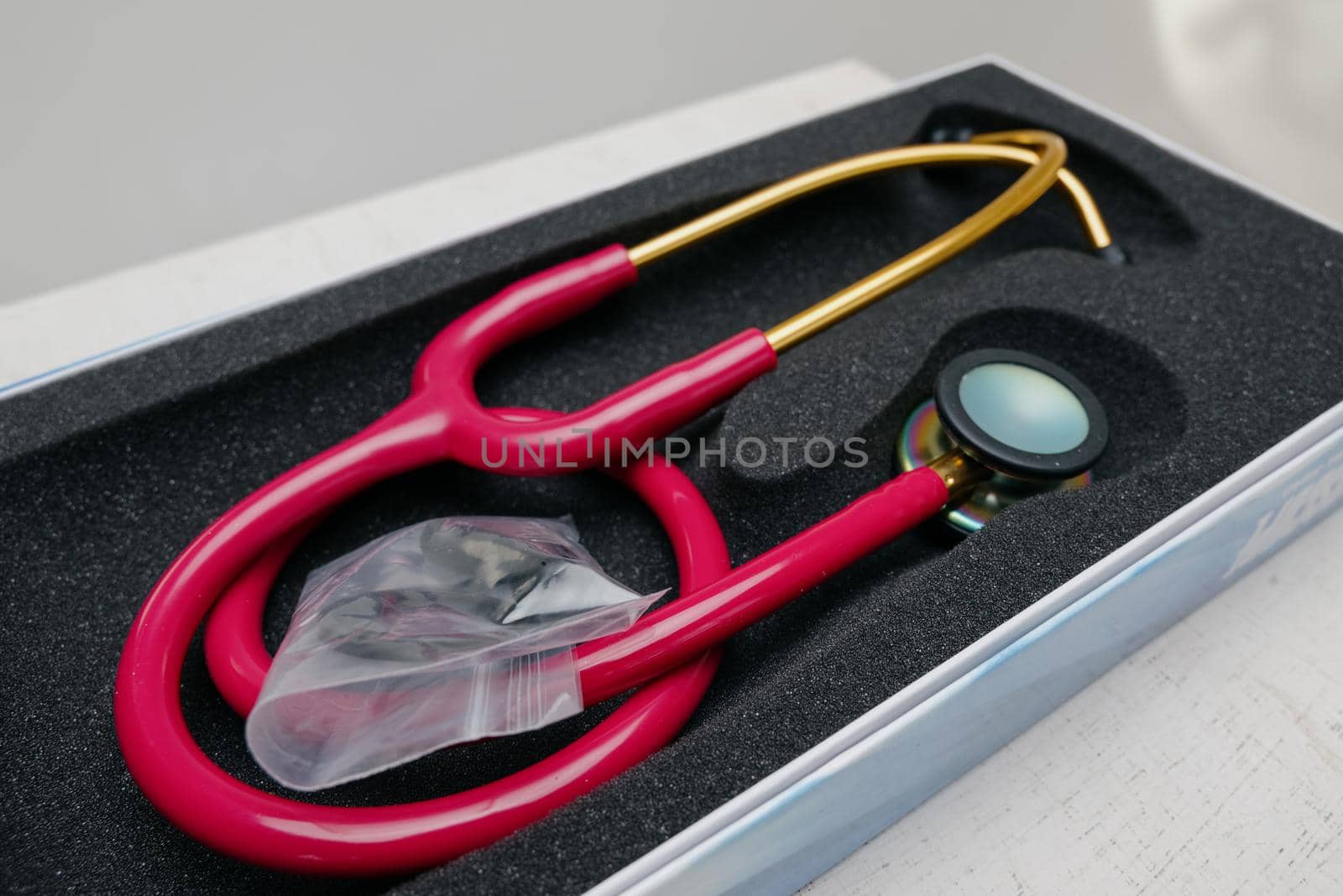 Medical stethoscope. Red medical stethoscope.The concept of healthcare.Stethoscope on a dark background