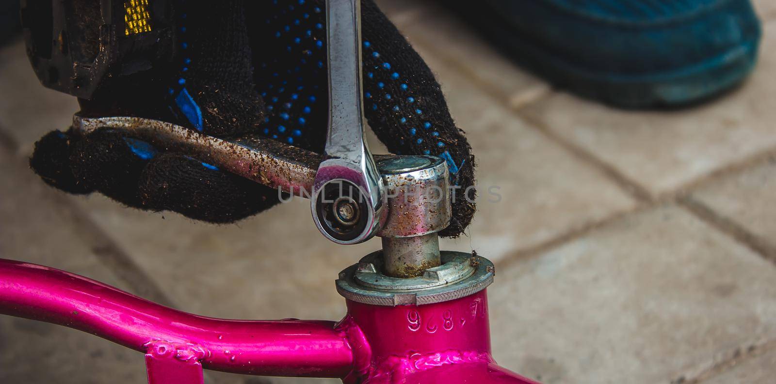 A father repairs his daughter's bike. selective focus
