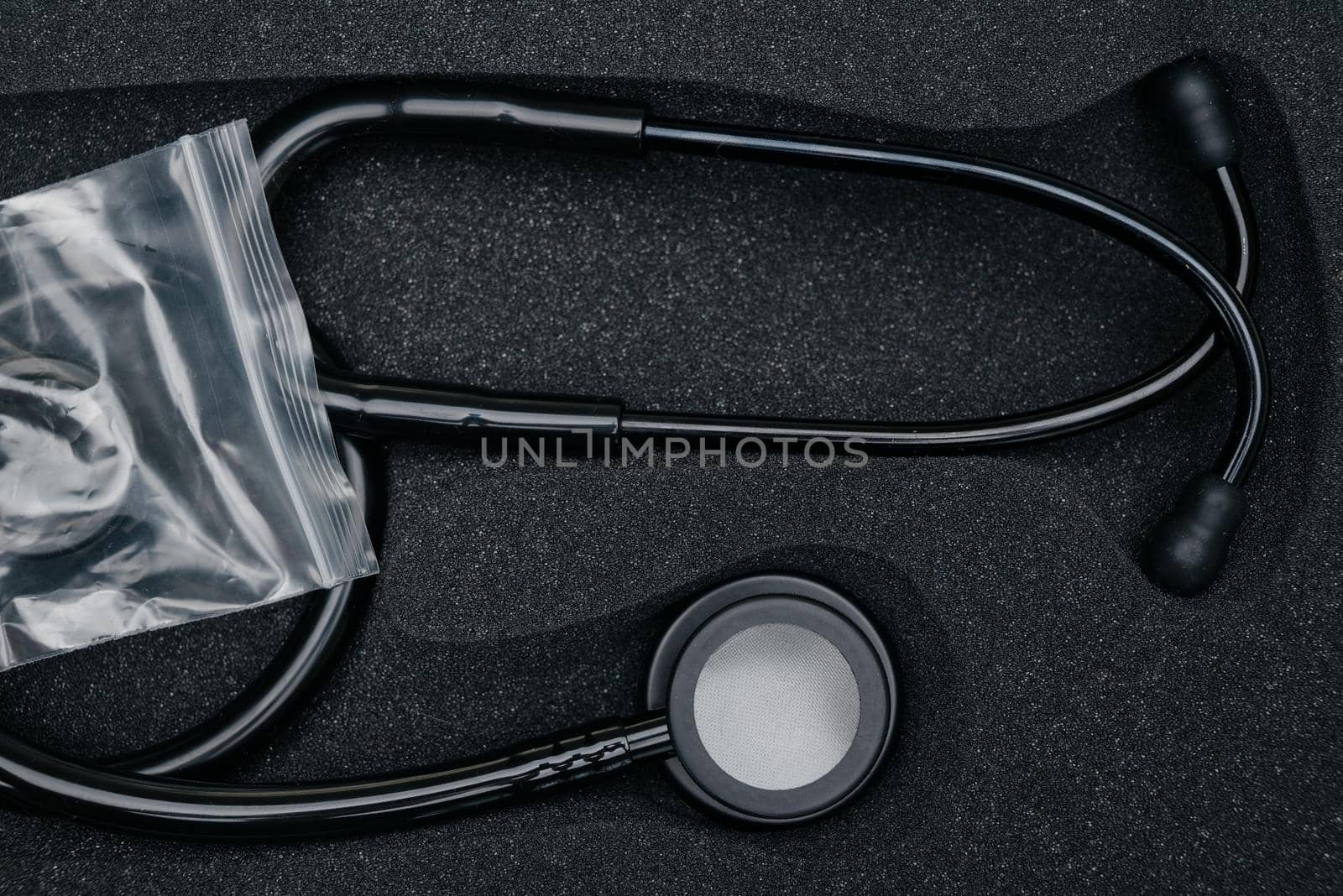 Medical stethoscope. Black medical stethoscope.The concept of healthcare.Stethoscope on a dark background