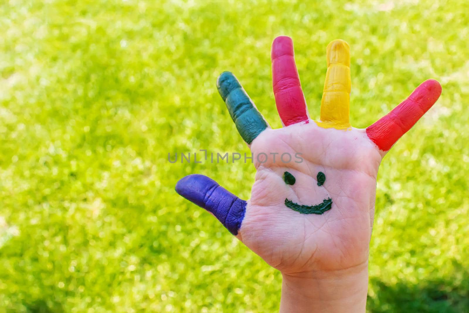 Children's hands in the colors of summer. Selective focus.nature