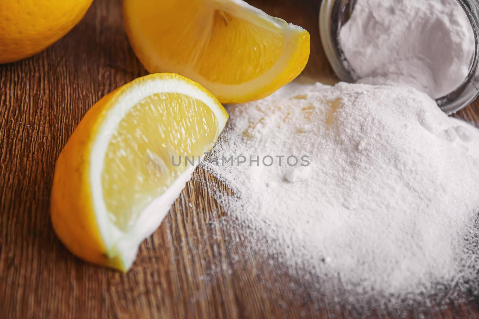 Citric acid on a wooden background with lemon. Selective focus.food