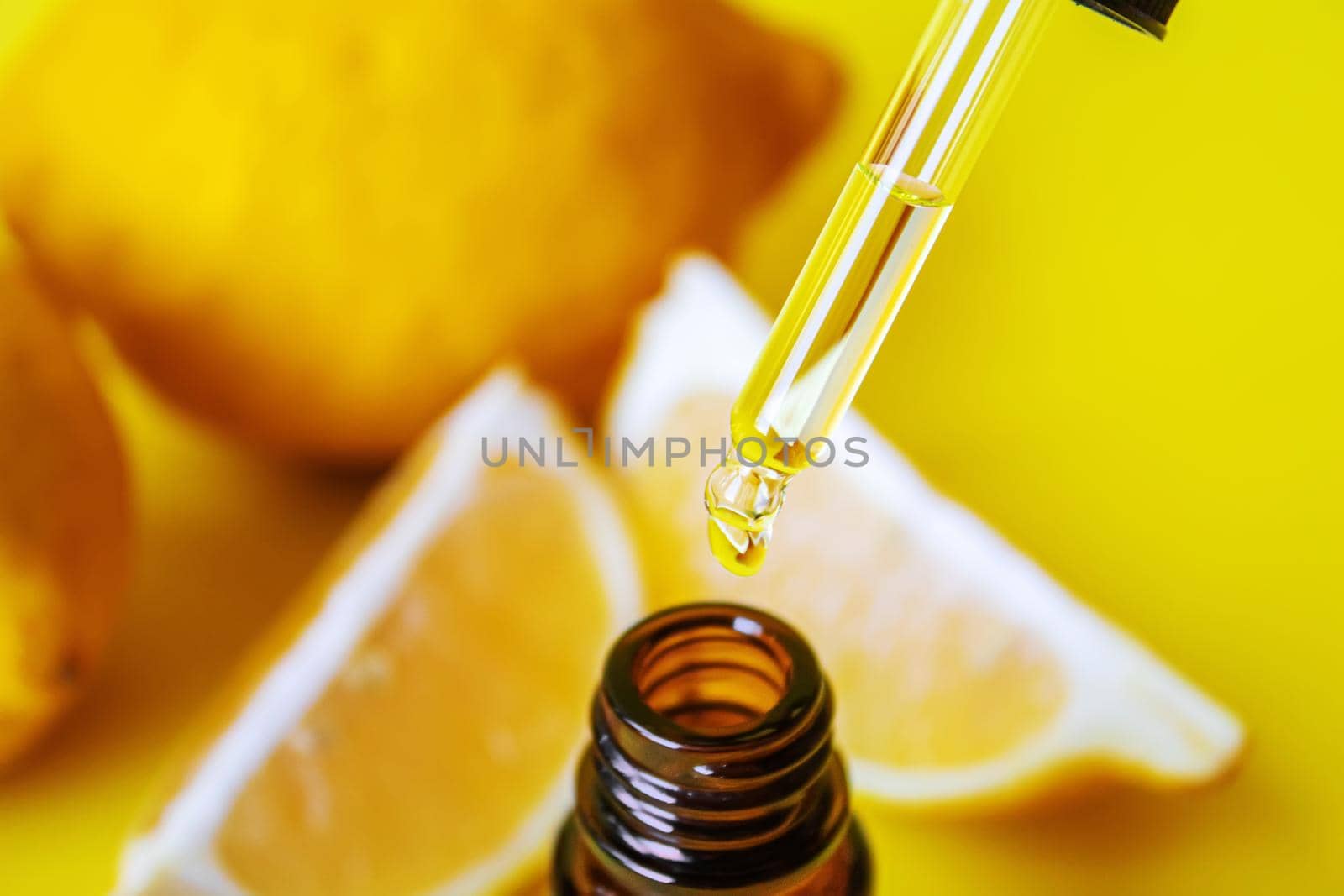 lemon essential oil on a yellow background. Selective focus.nature