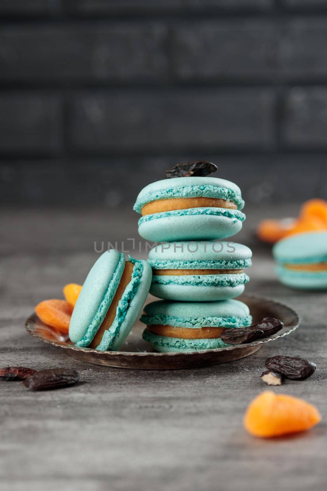 Blue macaroons on a grey concrete background. Vertical