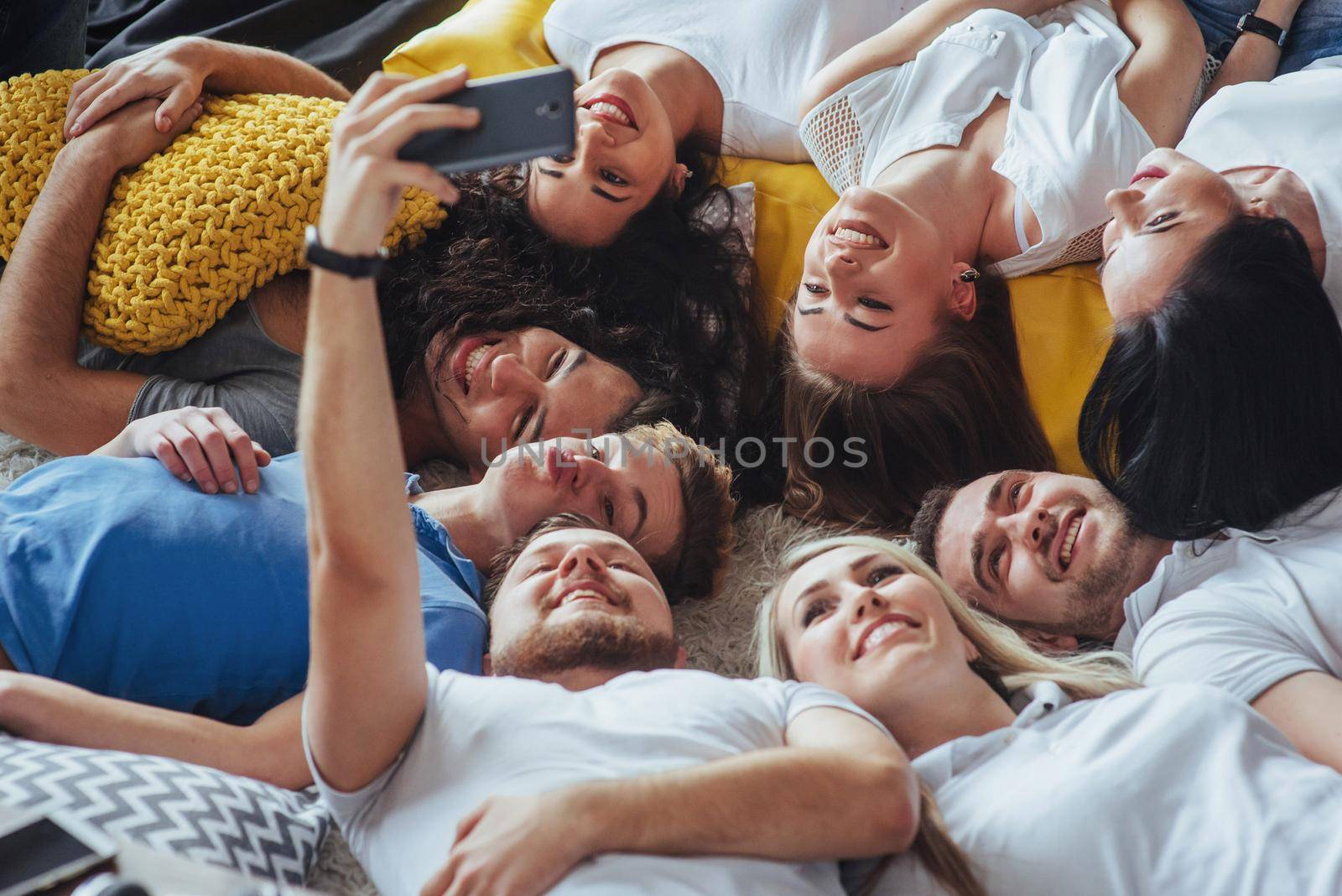 Group beautiful young people doing selfie lying on the floor, best friends girls and boys together having fun, posing emotional lifestyle people concept.