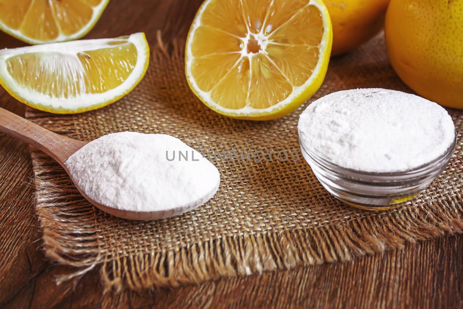 Citric acid on a wooden background with lemon. Selective focus.food