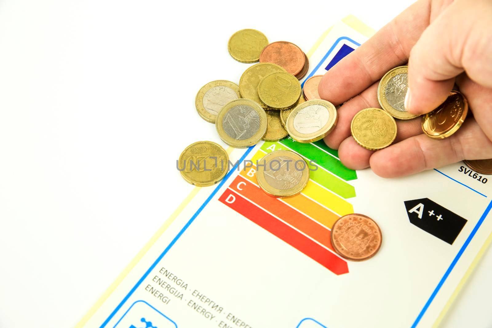 Madrid, Spain- May 9, 2022: European Union Energy Label next hand with coins
