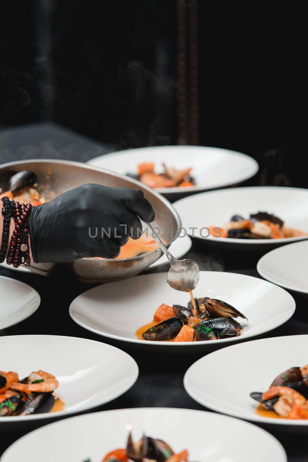 the chef prepares a seafood dish. the cook sets the table for the banquet by Ashtray25