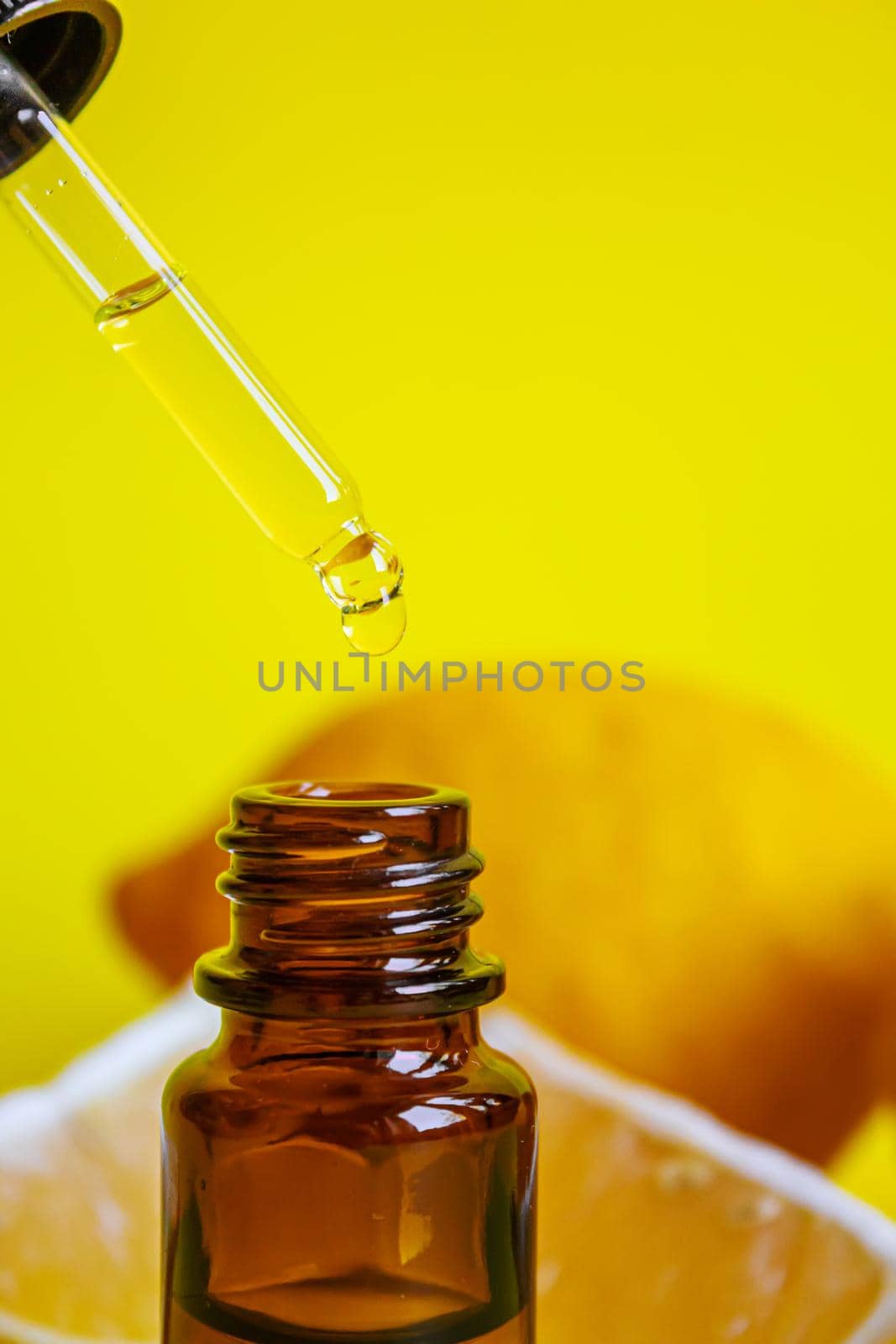 lemon essential oil on a yellow background. Selective focus.nature