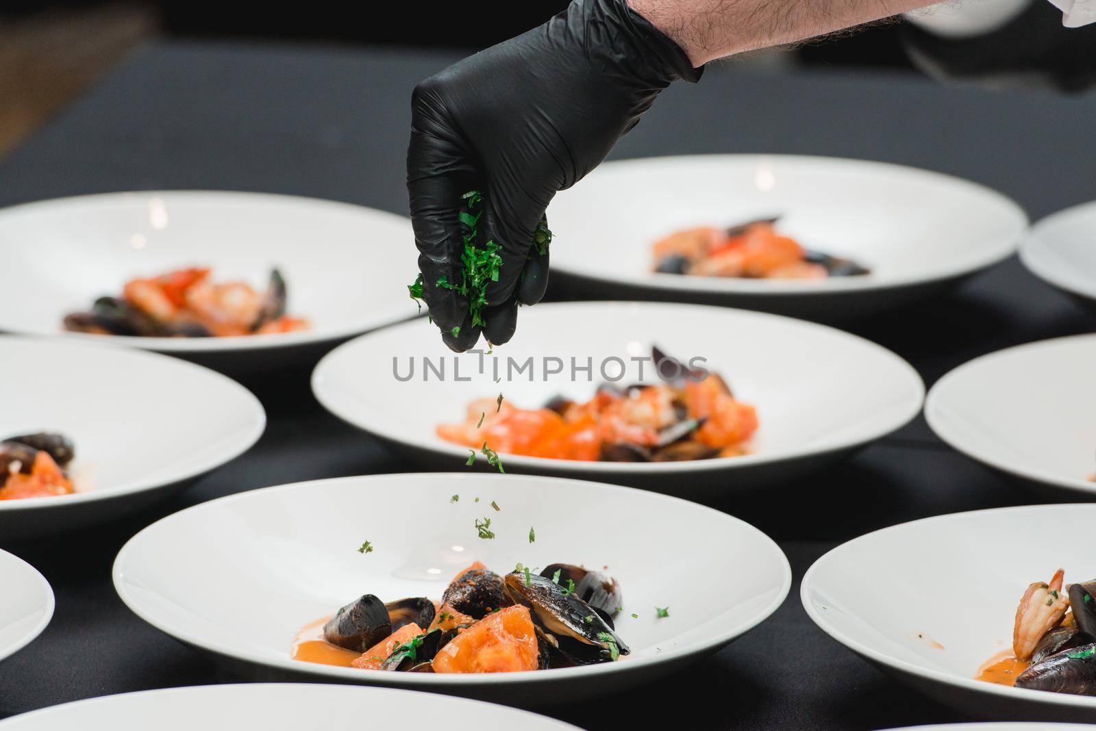 the chef prepares a seafood dish. the cook sets the table for the banquet by Ashtray25