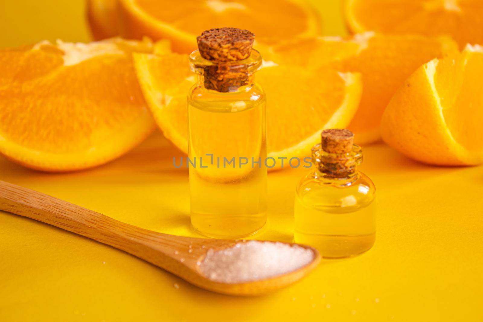 orange essential oil on a yellow background. Selective focus.nature