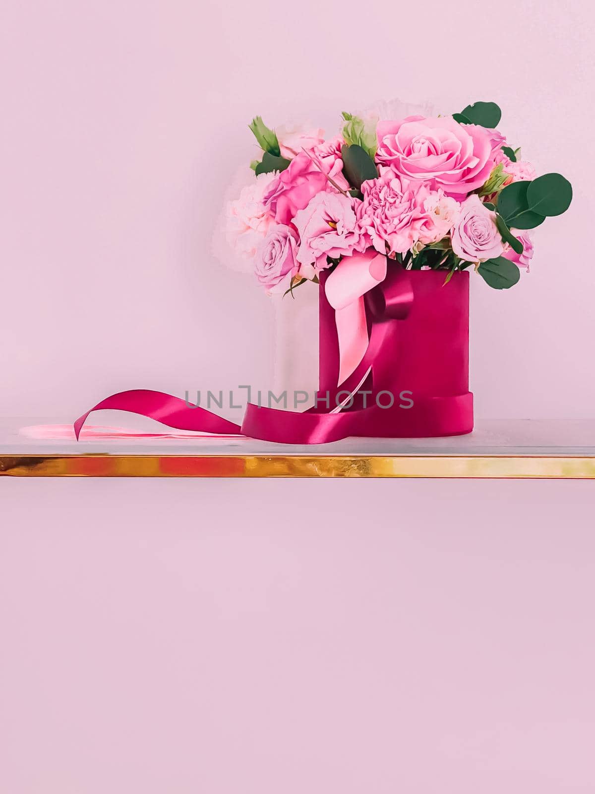 Beautiful bouquet of blooming flowers in flower box on pink background, holiday gift, luxury floral design by Anneleven