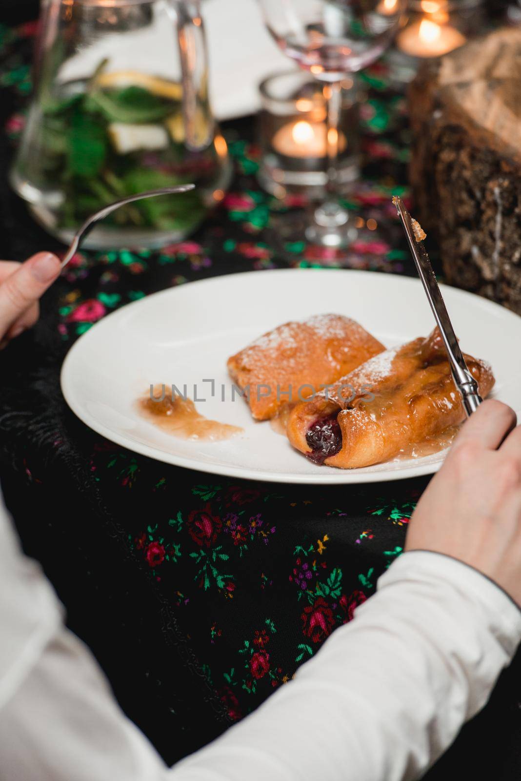 Woman eating flying buns with fruits on a white plate by Ashtray25