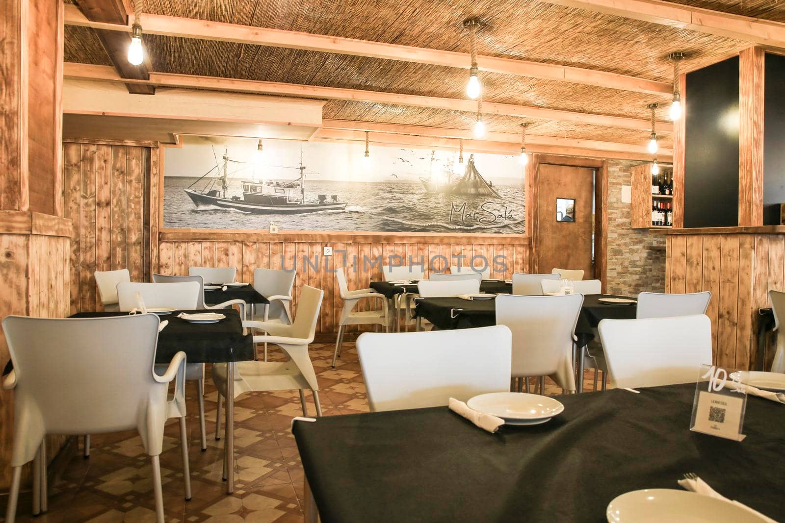 Alicante, Spain- May 6, 2022: Empty restaurant in Arenales del Sol beach with beautiful rustic style