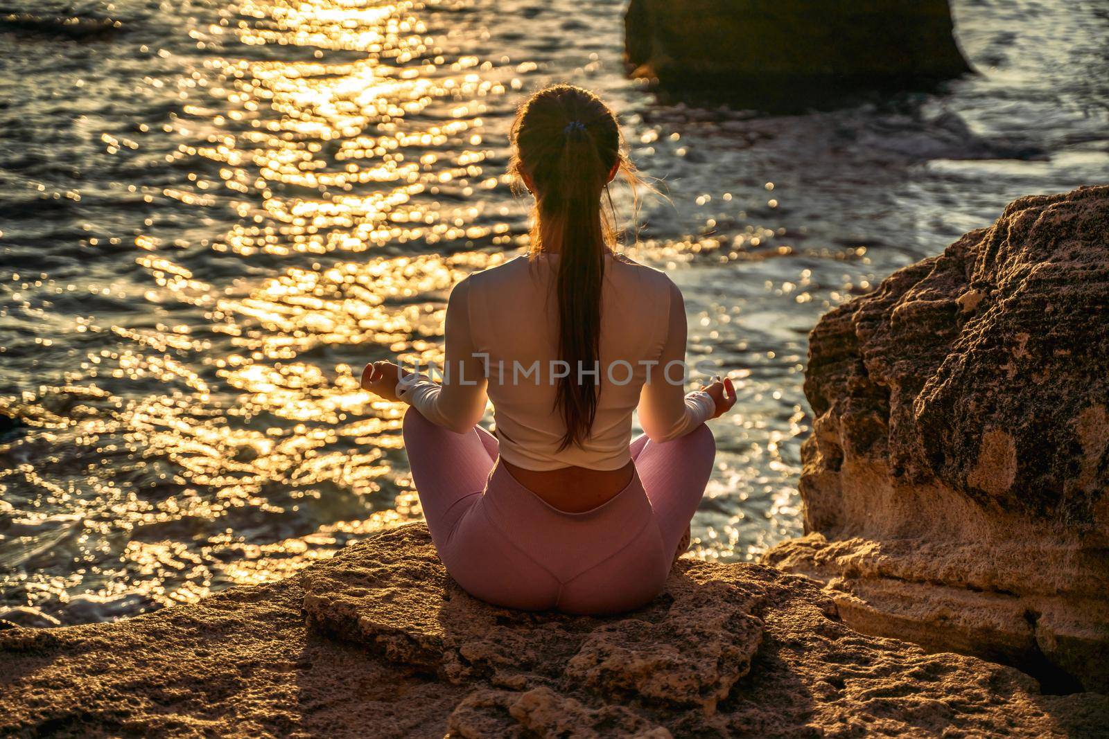 Young woman practicing yoga outdoors. Harmony and meditation concept. Healthy lifestyle.