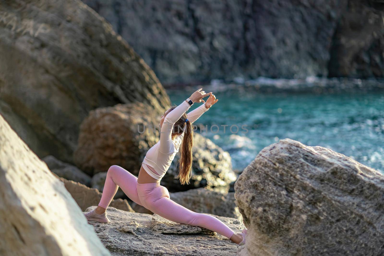 Girl gymnast trains on the beach by the sea. Photo series.