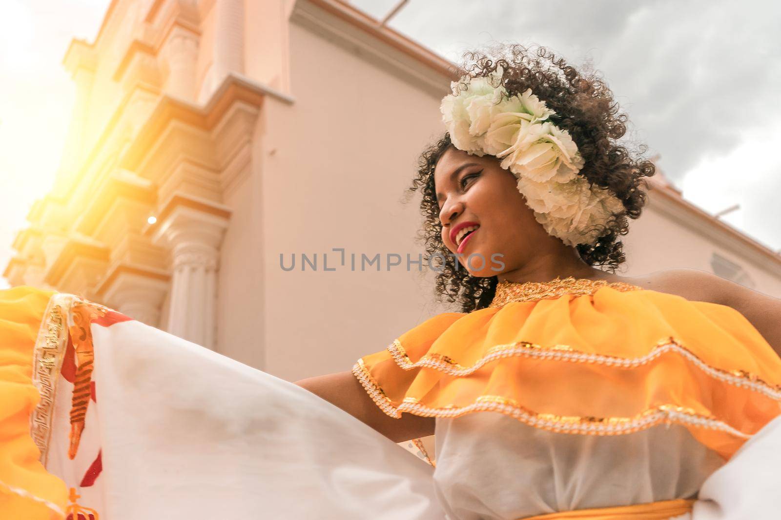 Traditional curly-haired mestizo dancer with a typical Nicaraguan costume dancing outside the cathedral of Leon Nicaragua celebrating the independence festivities