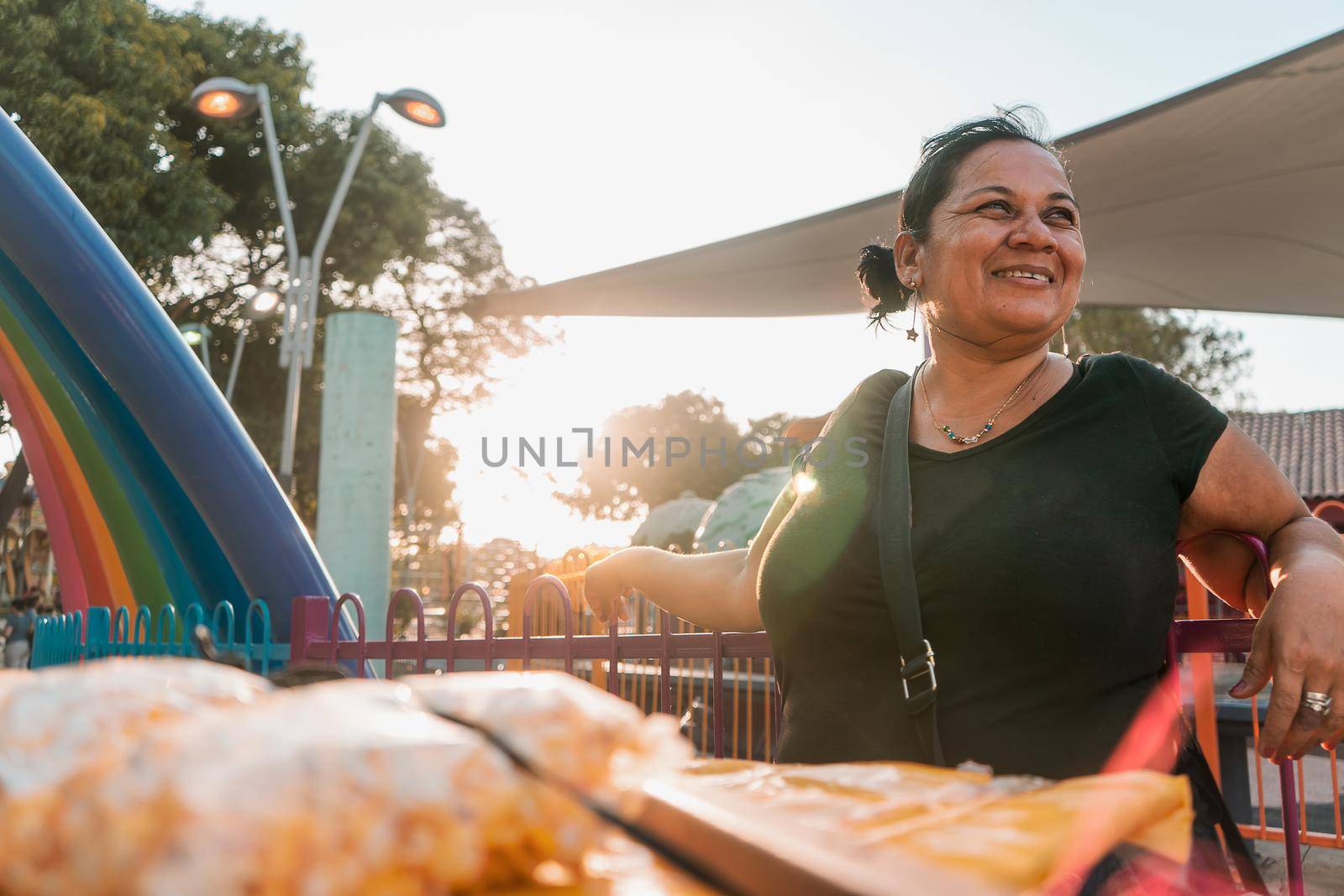 Itinerant fruit vendor in a park in Managua Nicaragua smiling at sunset. Concept of self-employment by cfalvarez
