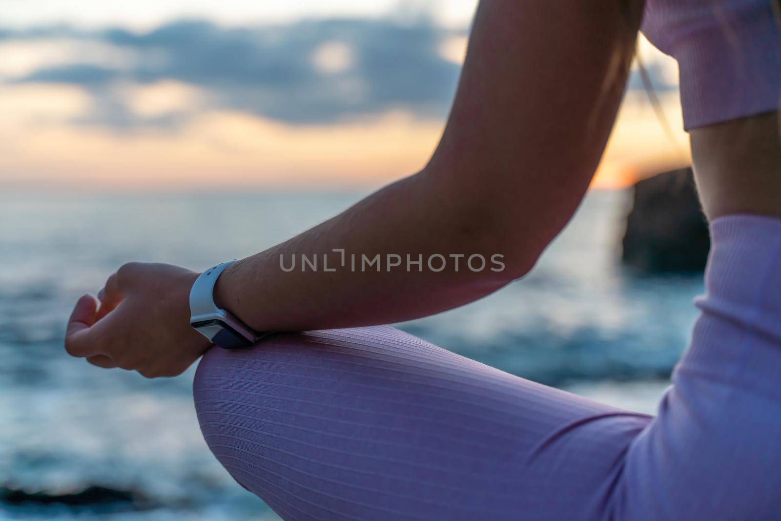 Young woman practicing yoga outdoors. Harmony and meditation concept. Healthy lifestyle by Matiunina