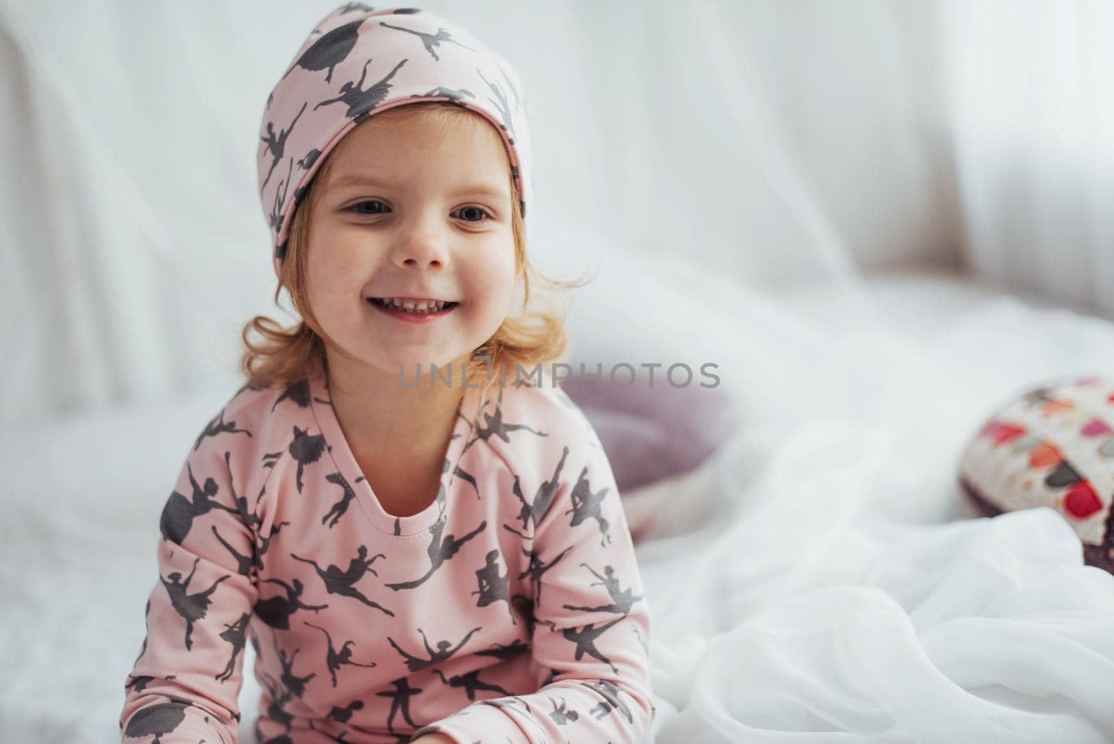 Child in soft warm pajama playing in bed
