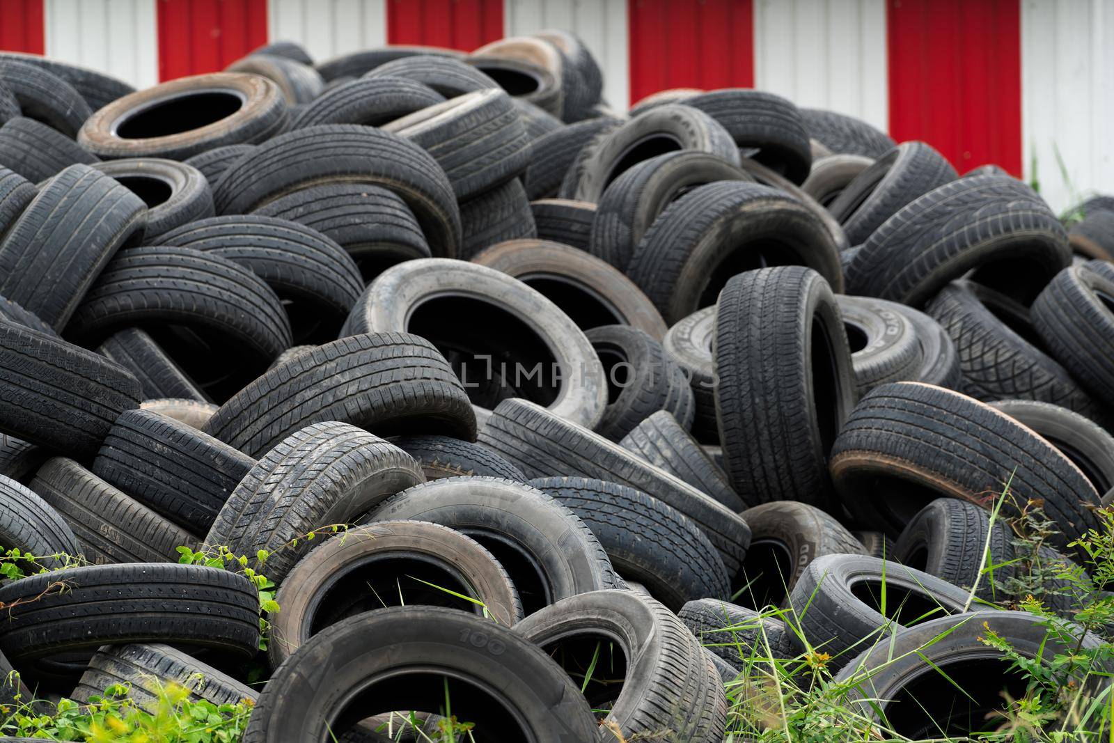 Pile of used tires. Old tyres waste for recycle or for landfill. Black rubber tire of car. Pile of used tires at recycling manufacturing yard. Material for landfill. Pile of second hand tires for sale