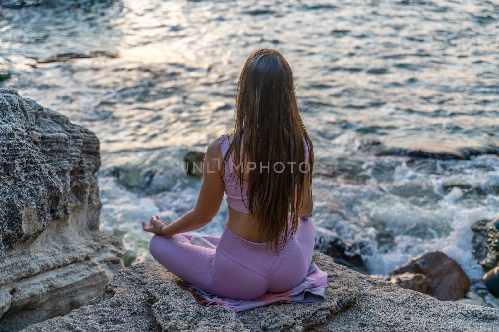 Young woman practicing yoga outdoors. Harmony and meditation concept. Healthy lifestyle.