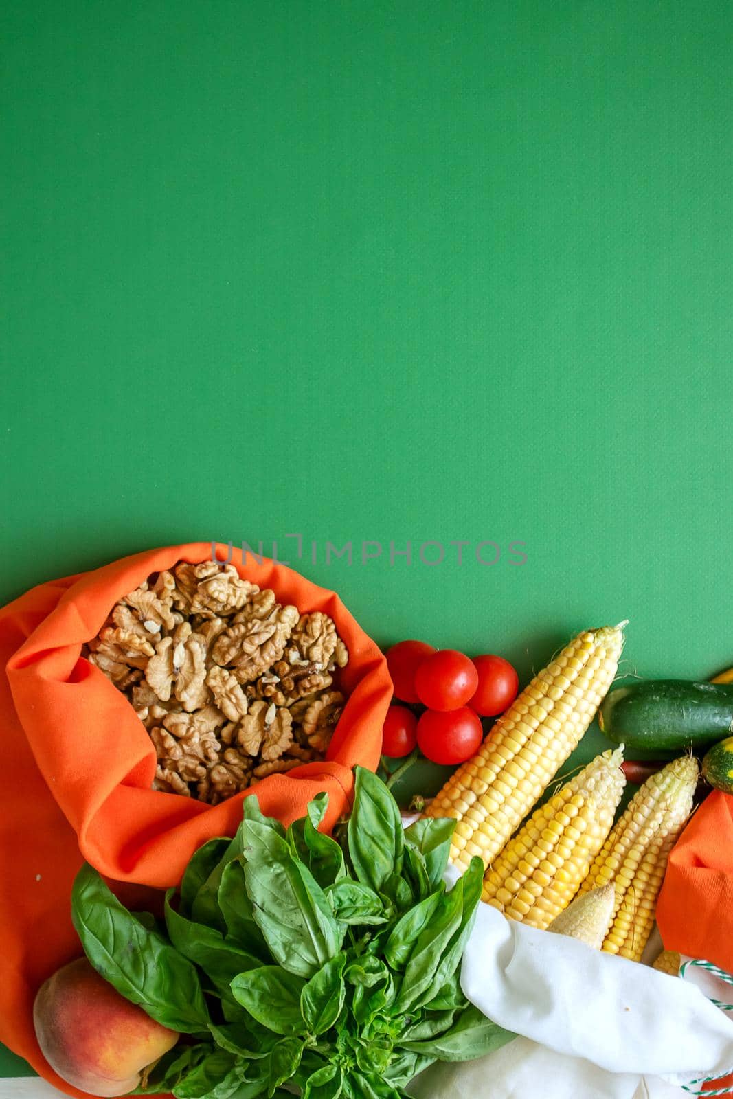 zero waste products in reusable cotton bags on a green background. High quality photo