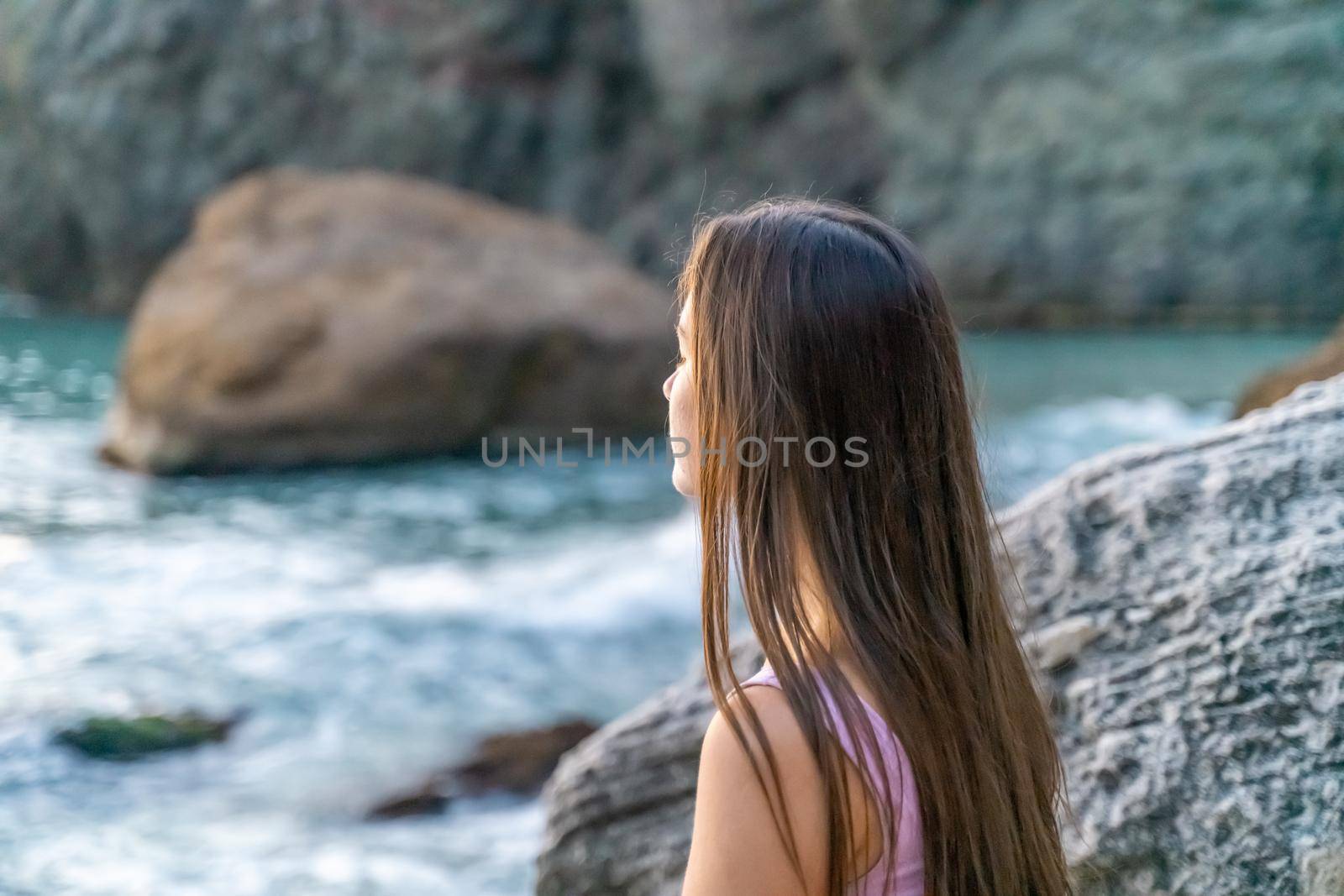 Young woman practicing yoga outdoors. Harmony and meditation concept. Healthy lifestyle.