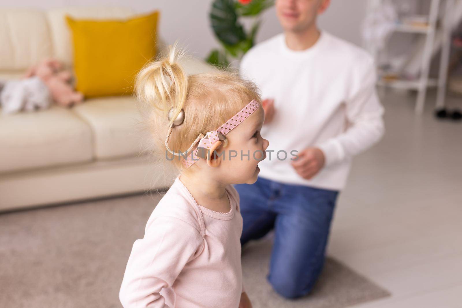 Cochlear implant on the child girl head. Hearing aid and deafness and innovative health technology