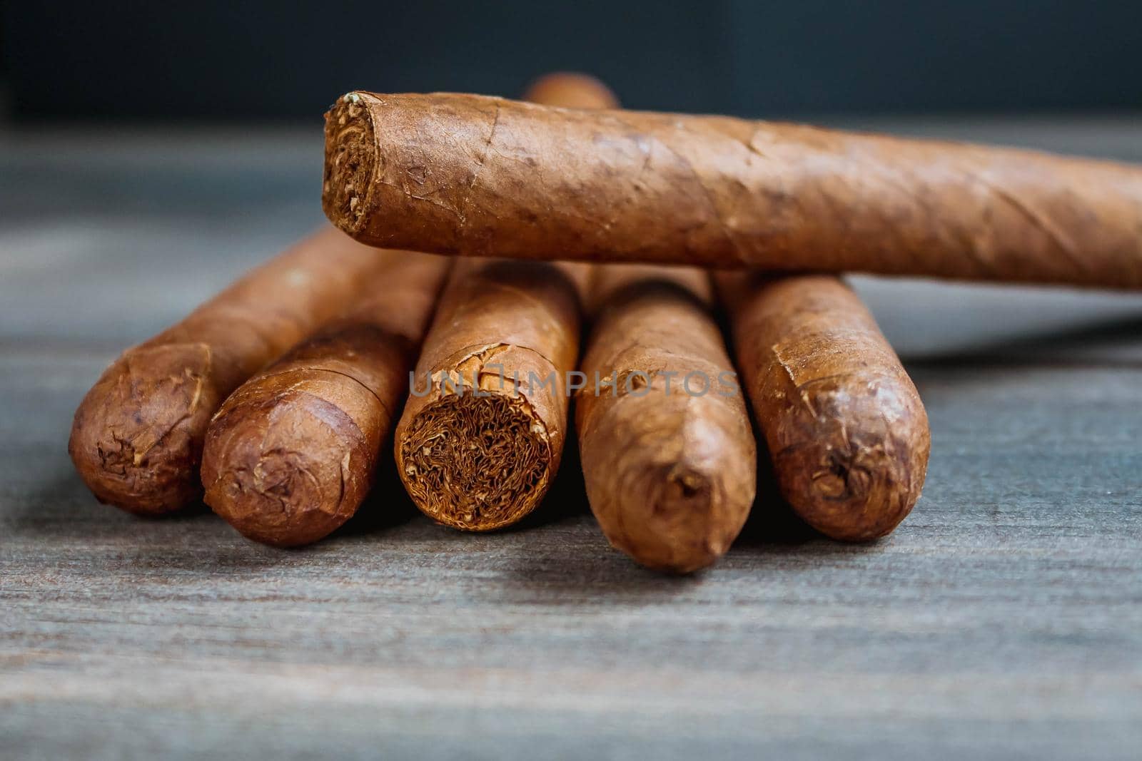 Close view of cigars on the wooden background