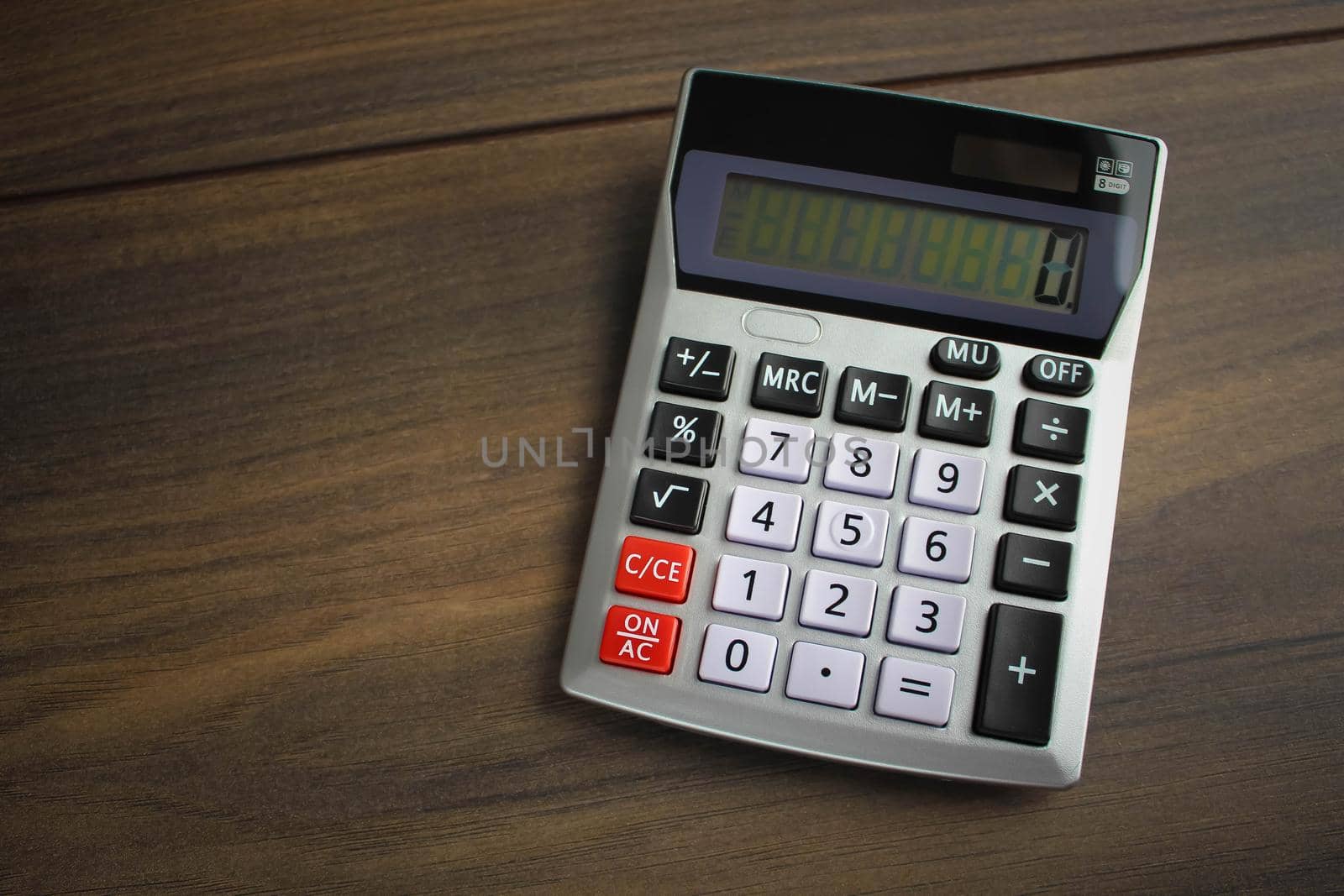 Calculator in office on empty wooden table. Concept of financial business