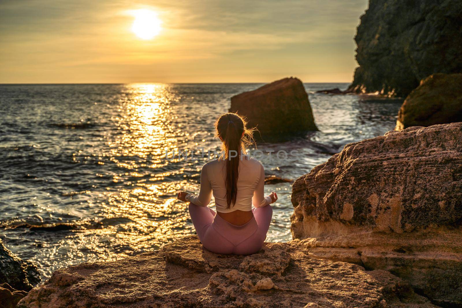 Young woman practicing yoga outdoors. Harmony and meditation concept. Healthy lifestyle by Matiunina