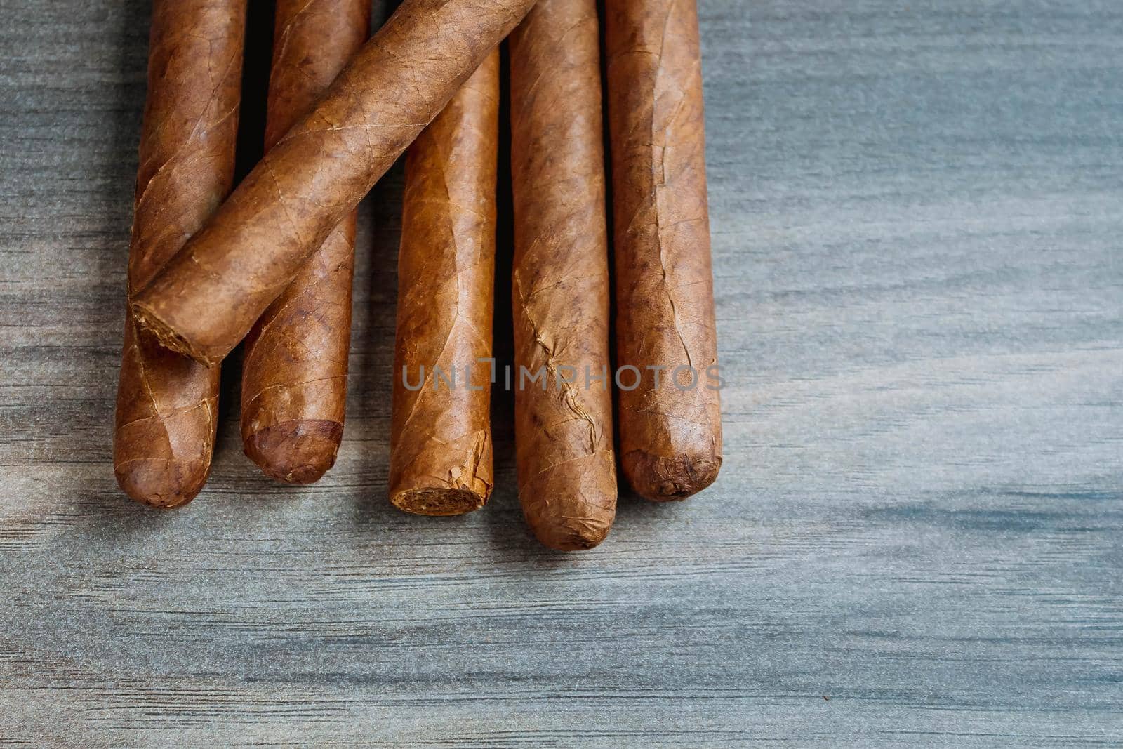 Close view of cigars on the wooden background by JuliaDorian