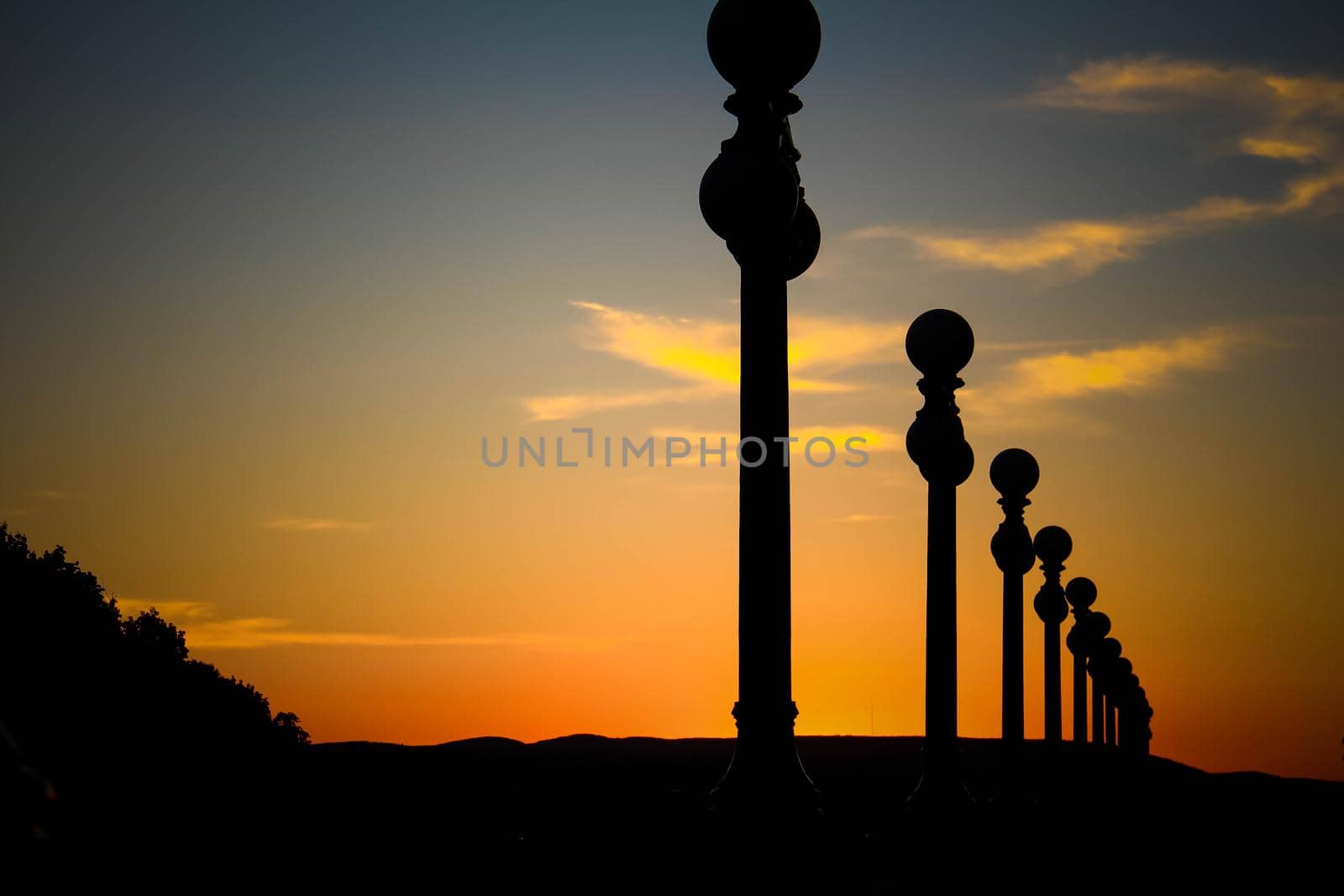 Silhouette of street lanterns with sunset sky. Silhouette of a street lamp post during a beautiful sunset. by JuliaDorian