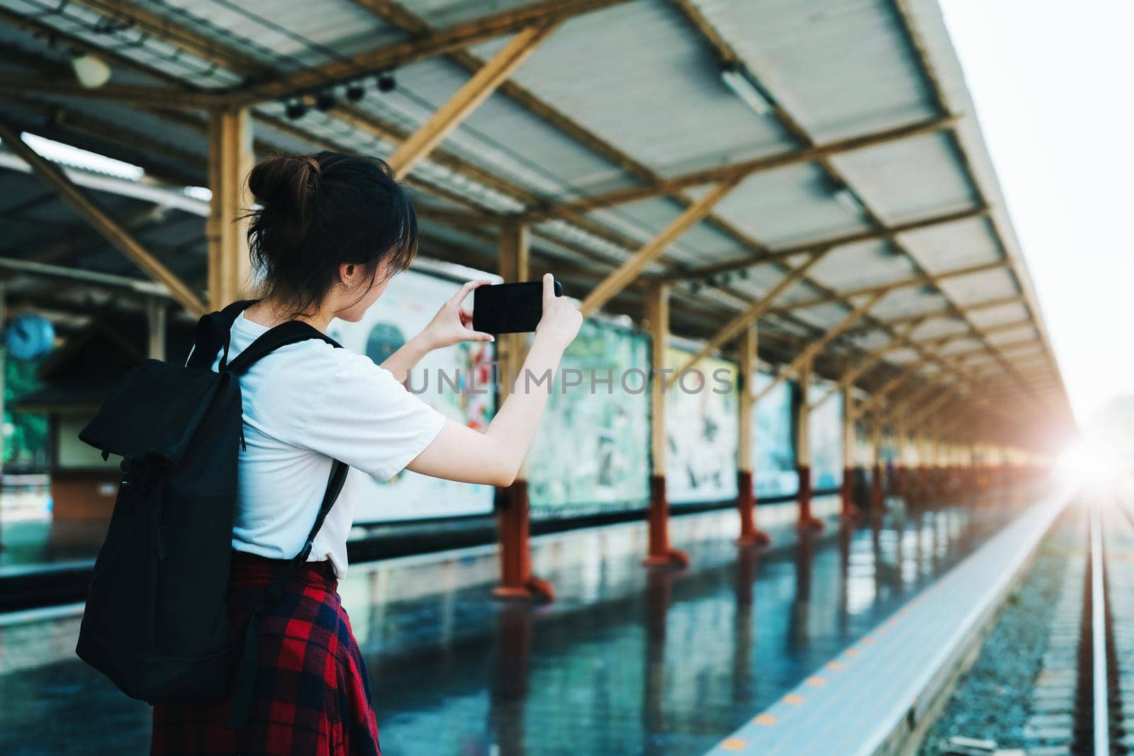 summer, relax, vacation, travel, portrait of beautiful Asian girl using the smartphone mobile take a photo at the train station while waiting for their travel time. by Manastrong