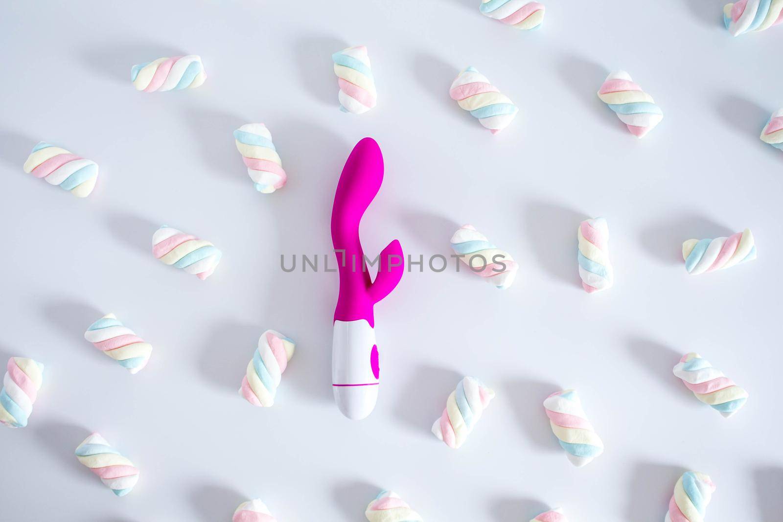 Pink dildo toy with pastel twisted marshmallows isolated on white background. Soft shadows. by JuliaDorian