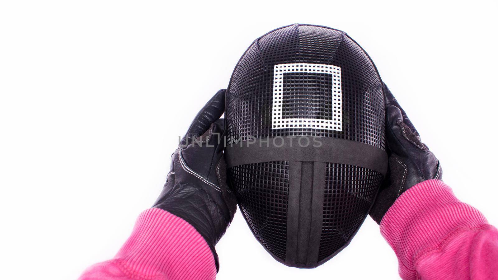 POV view of hands of Squid Game pink guard holding a mask on white background. Space for text. Red Guard from Squid Game of new Netflix show. Gatineau, Quebec Canada - November 2, 2021
