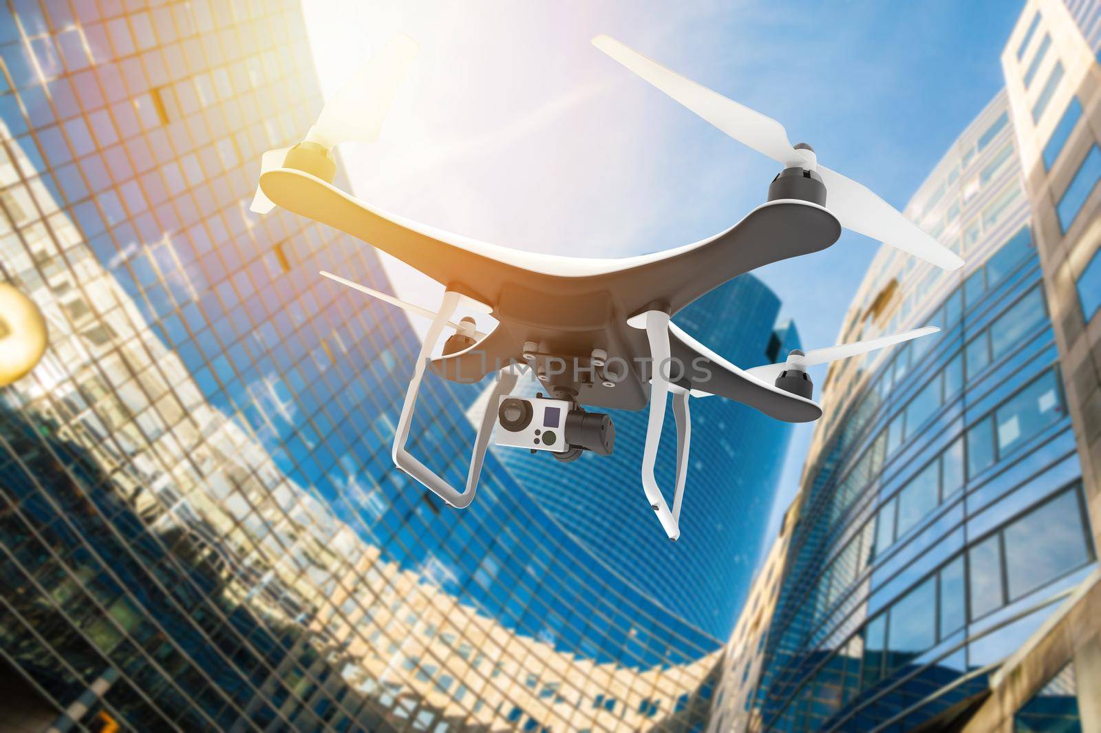 Drone with digital camera flying in a modern city at sunset: 3D rendering