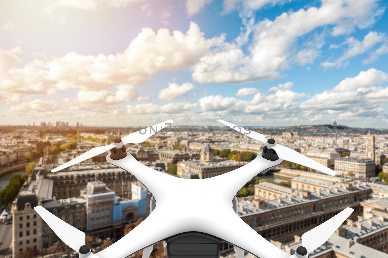 Drone with digital camera flying over a city with blue sky: 3D rendering