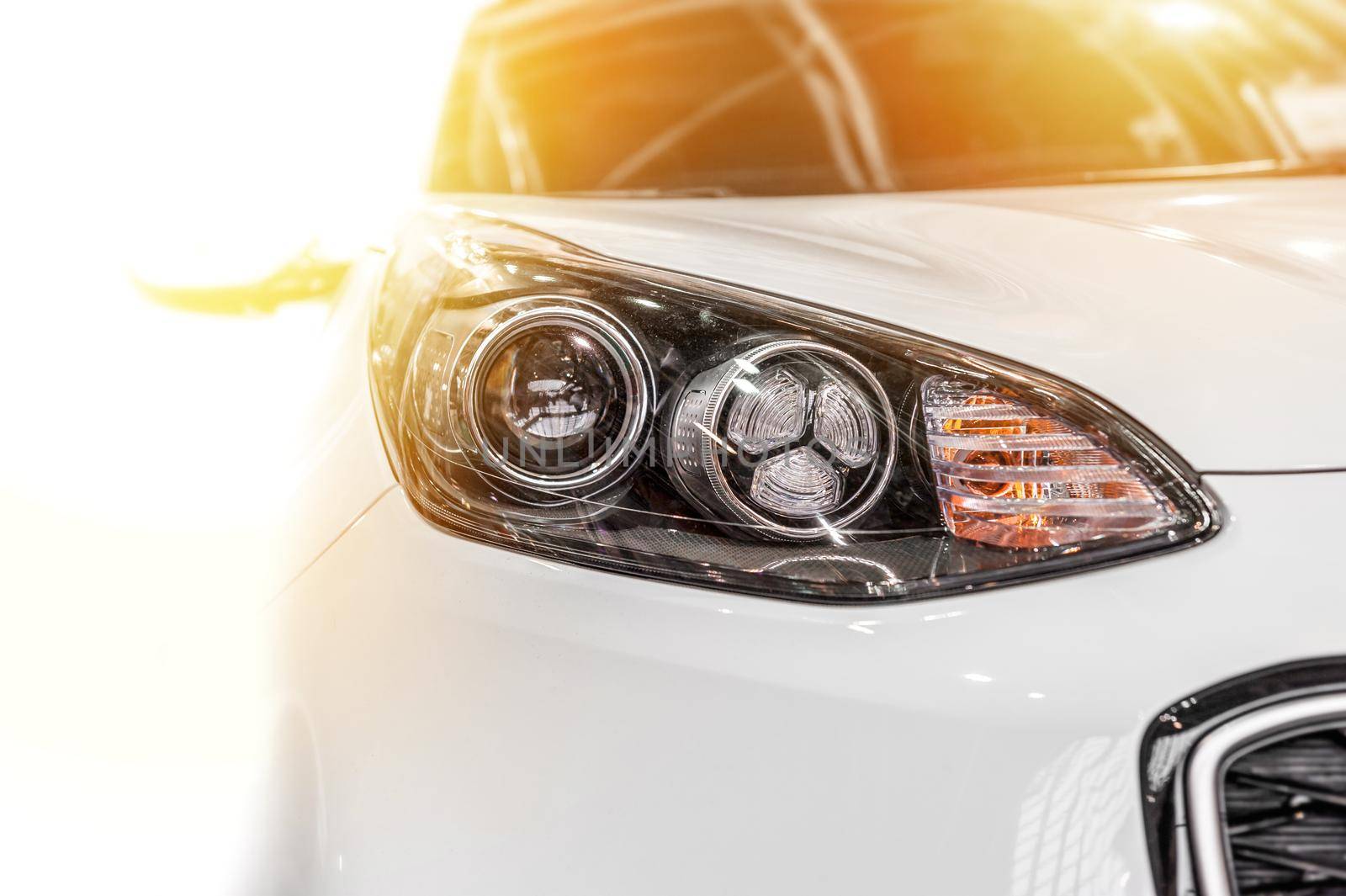 Modern sport car isolated on a white background with sunlight