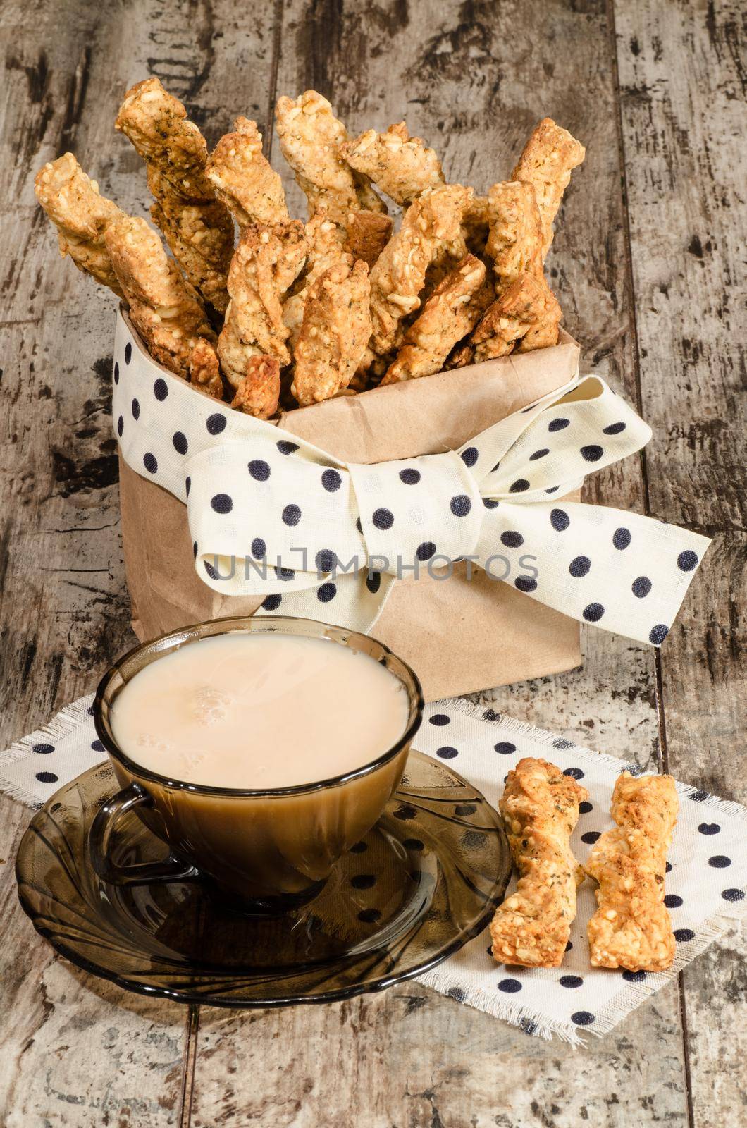 Garlic cheese bread sticks and cup of black tea with milk From series Homemade bread