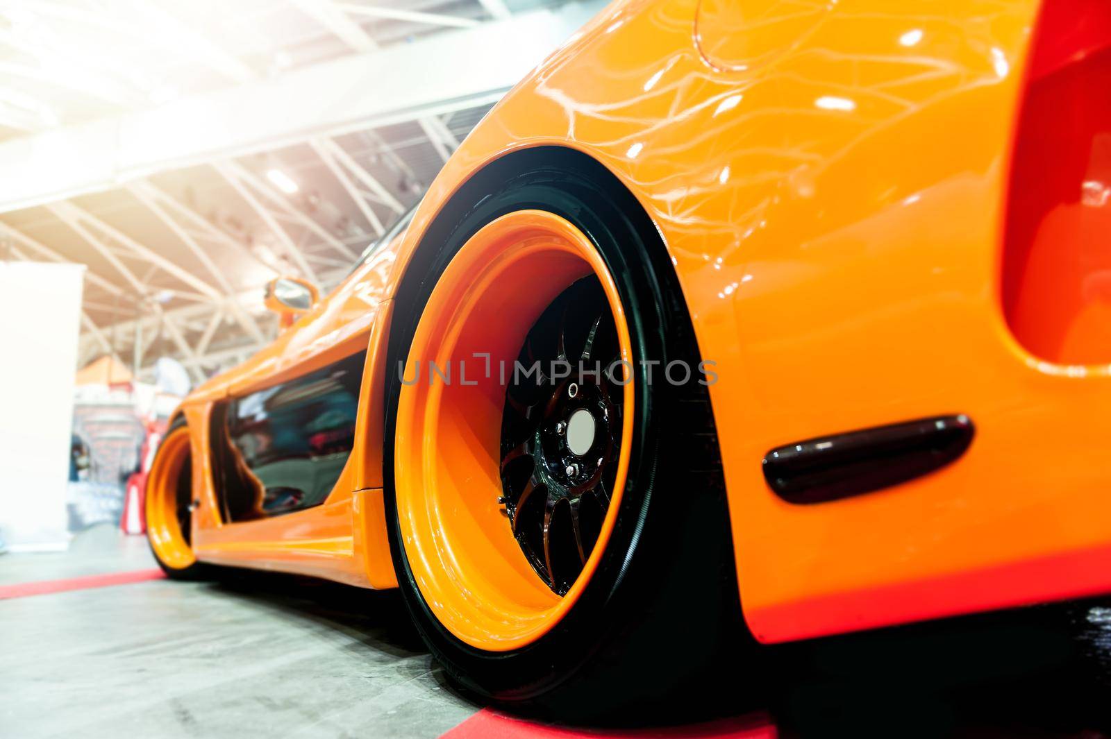 Back of a generic orange sport car in sunlight