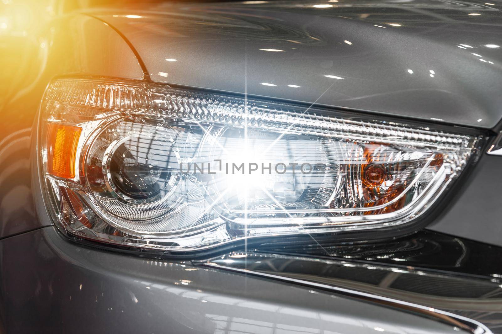 Closeup on an headlight of a sport car by cla78