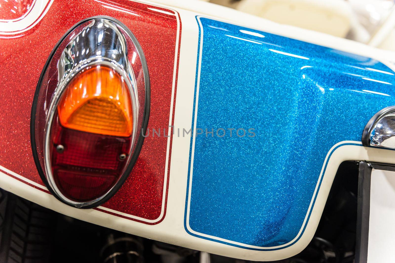 Back of a red, blue and white sport car: closeup