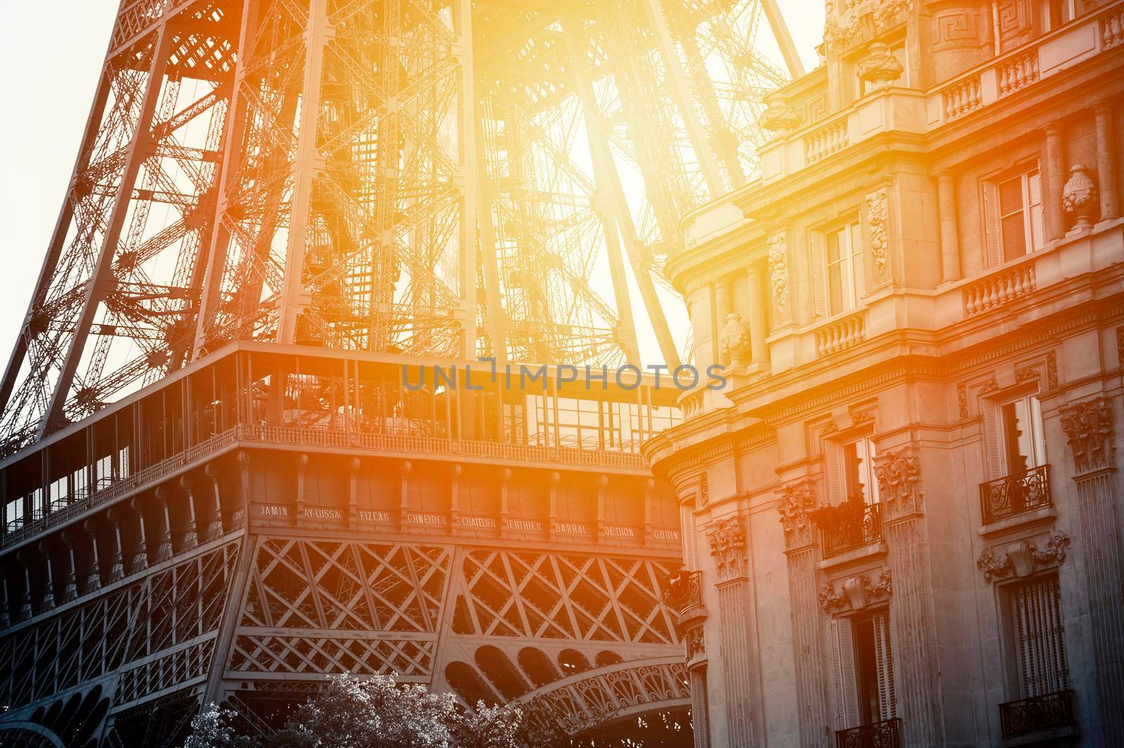 Close up of a black and white tour eiffel and a palace in Paris with sunset.