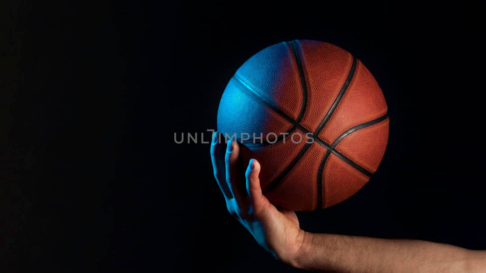 front view basketball held by male hand