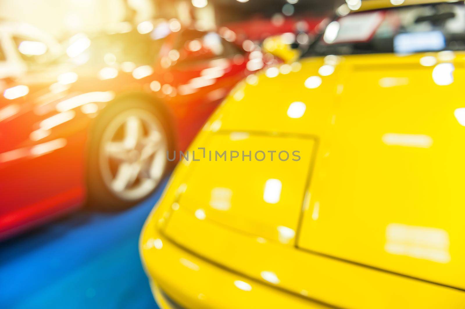 Two sport cars with defocus effect in the sunlight