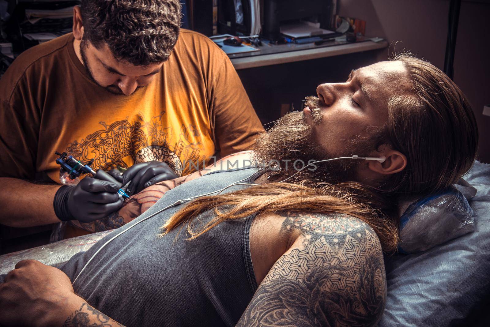 Tattoo master posing in studio by Proff
