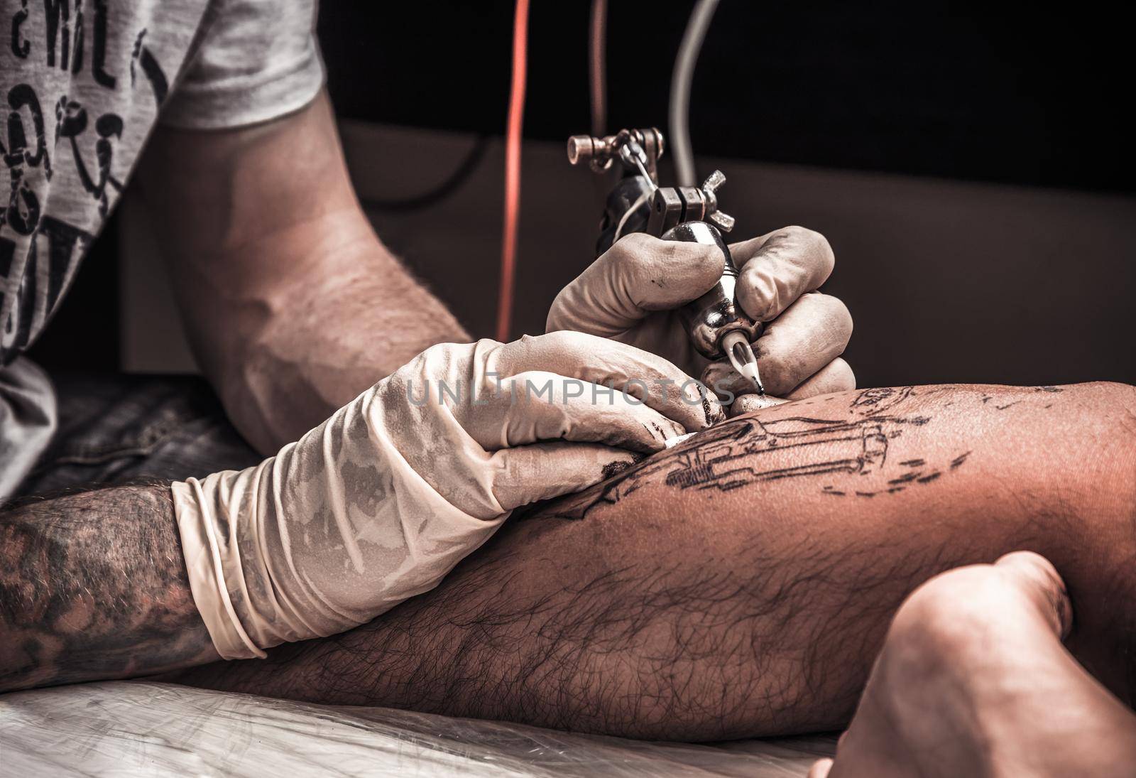Tattoo artist at the process of the tatoo making
