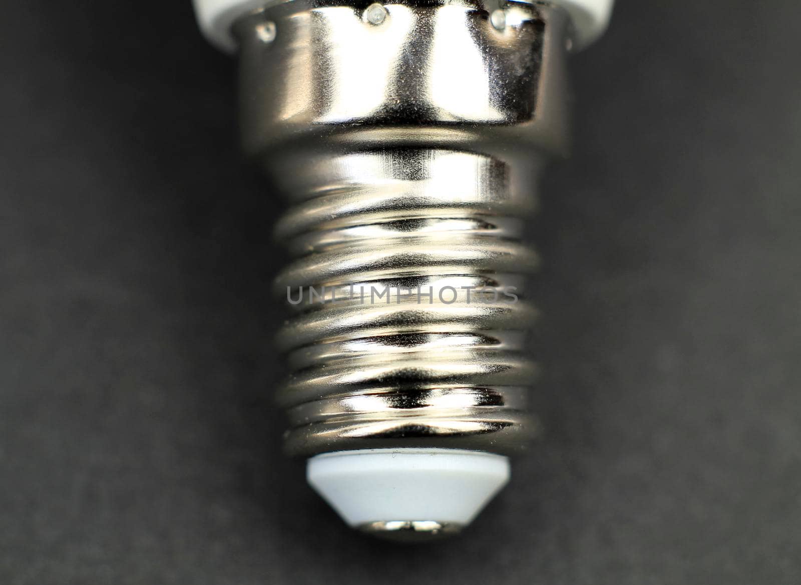 E14 Led bulb base macro photography on black background