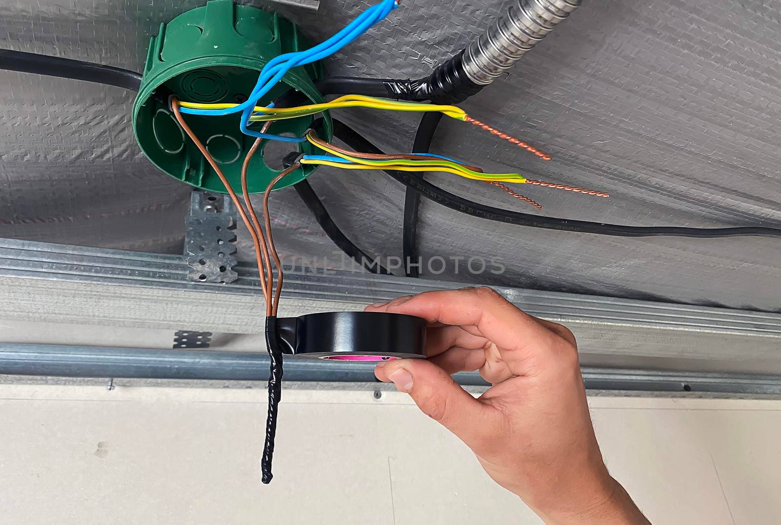Electrical wiring of the junction box, installation, twisting of the box by an electrician. Selective focus.